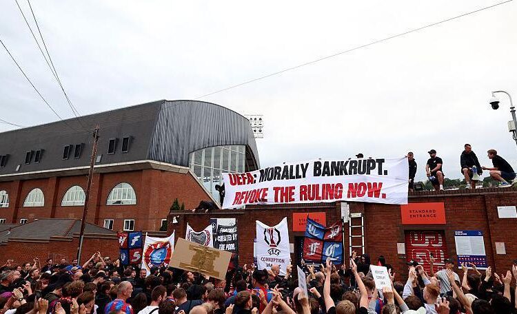 Crystal Palace fans protest UEFA decision to demote club to Conference League.
